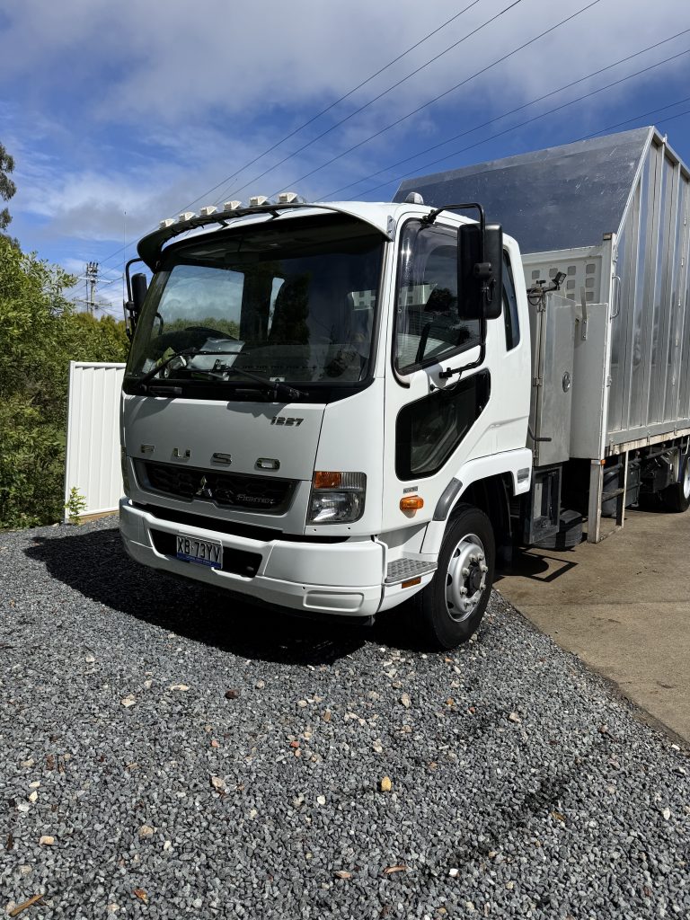 White Fuso work truck after a detail
